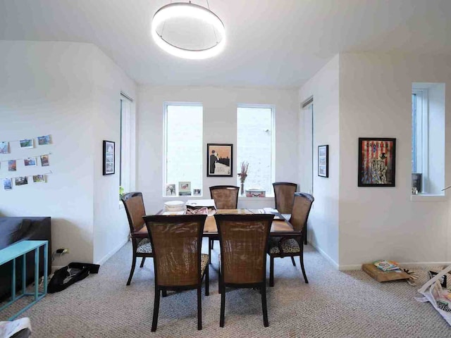 dining space with carpet flooring