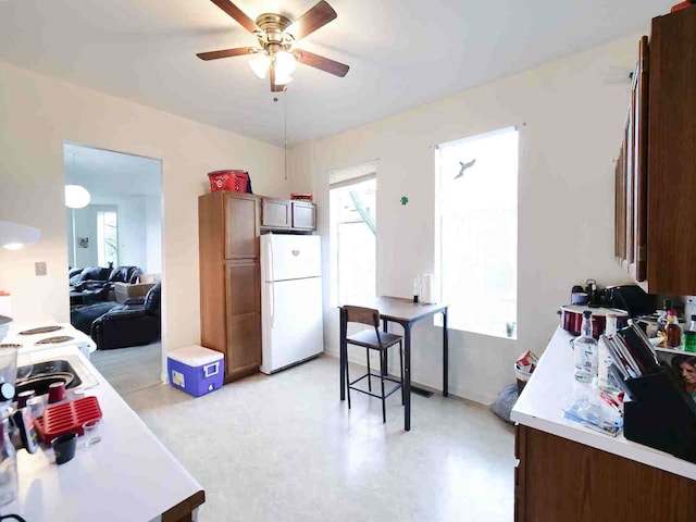 kitchen with white fridge, plenty of natural light, and ceiling fan