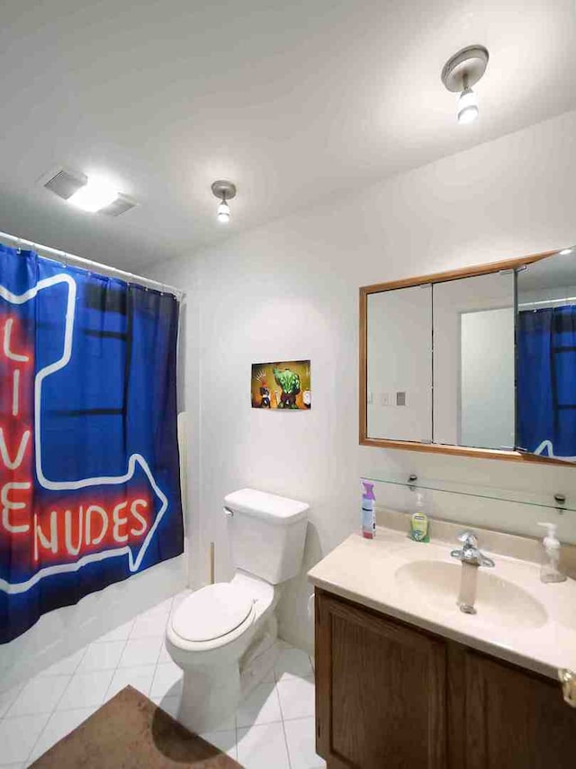 bathroom with walk in shower, vanity, toilet, and tile patterned floors