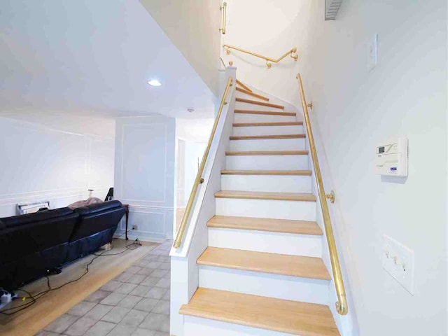 stairway with tile patterned flooring