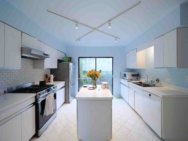 kitchen with white cabinetry, stainless steel appliances, track lighting, and sink