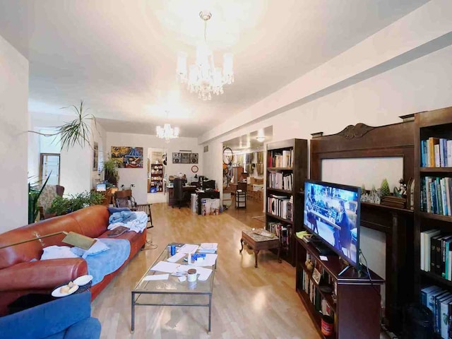 living room featuring a chandelier and light wood-type flooring