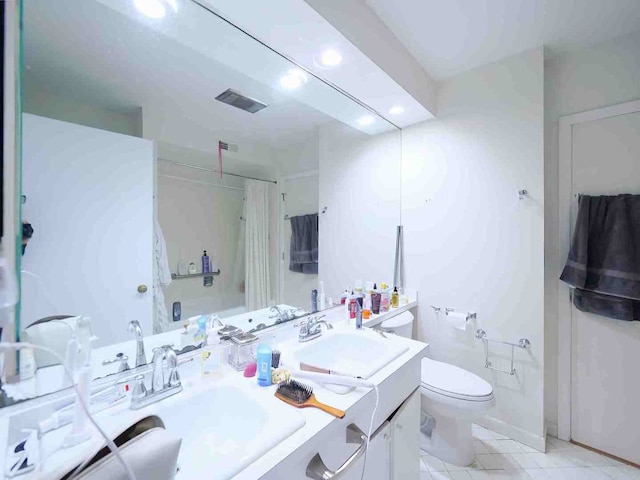 bathroom with toilet, a shower with curtain, vanity, and tile patterned flooring