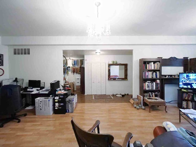 living room featuring hardwood / wood-style flooring and an inviting chandelier