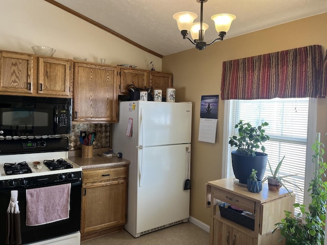 kitchen with white refrigerator, gas range oven, decorative light fixtures, vaulted ceiling, and a chandelier