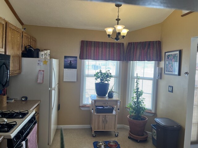 kitchen featuring a chandelier, range with gas cooktop, and decorative light fixtures