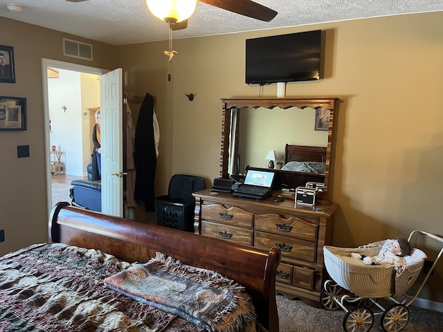 bedroom with ceiling fan and a textured ceiling