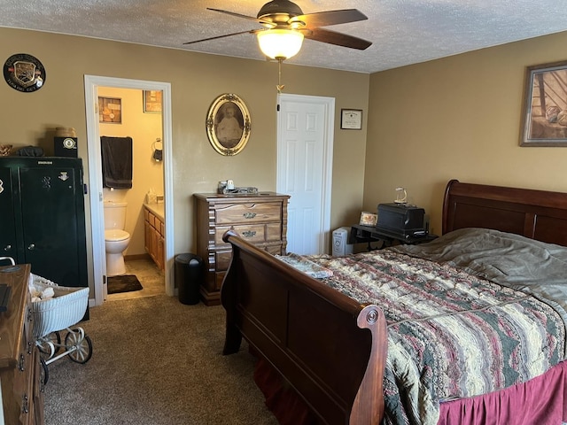 bedroom with ceiling fan, carpet floors, a textured ceiling, and ensuite bath