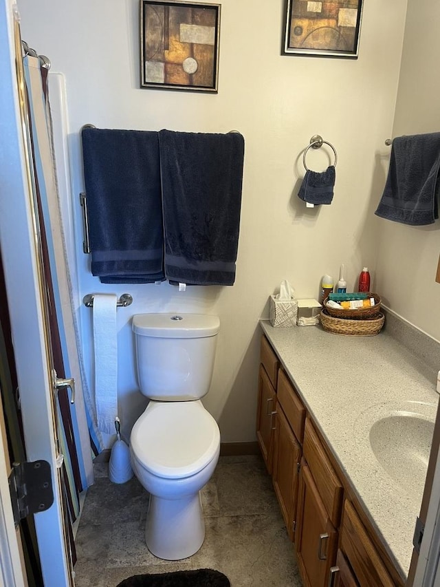 bathroom featuring vanity, a shower, and toilet