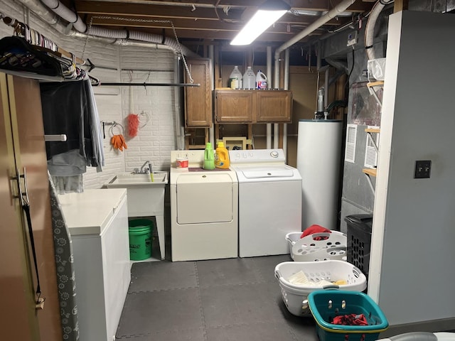 washroom with cabinets, washing machine and dryer, and water heater