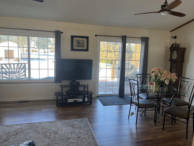 dining area with dark wood-type flooring, ceiling fan, and vaulted ceiling