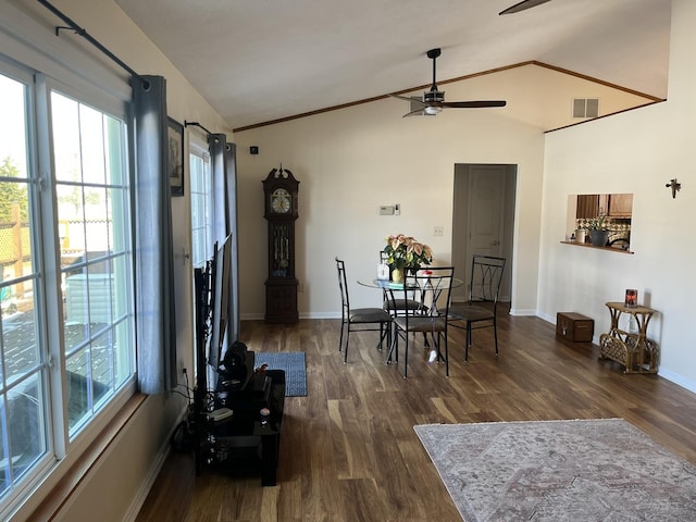 dining room featuring dark wood-type flooring, ceiling fan, plenty of natural light, and vaulted ceiling