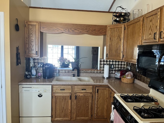 kitchen featuring sink, decorative backsplash, and black appliances