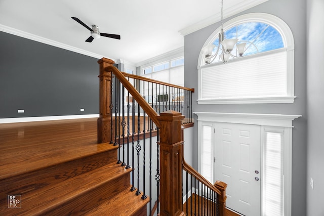 entrance foyer with crown molding and plenty of natural light