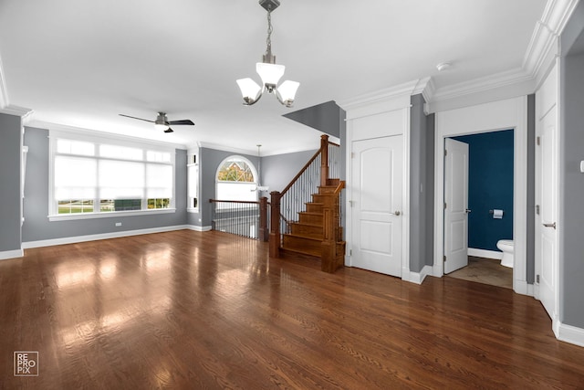 unfurnished living room featuring ornamental molding, dark hardwood / wood-style flooring, and ceiling fan with notable chandelier