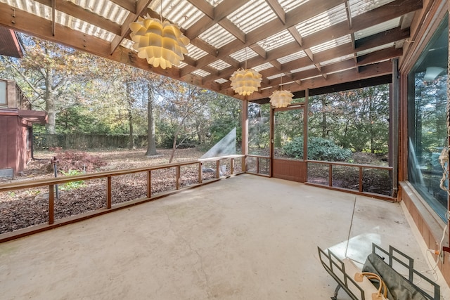 unfurnished sunroom featuring a chandelier