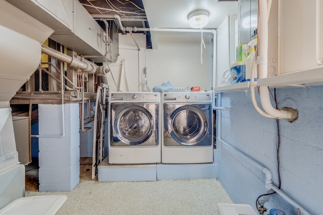 washroom featuring cabinets and independent washer and dryer