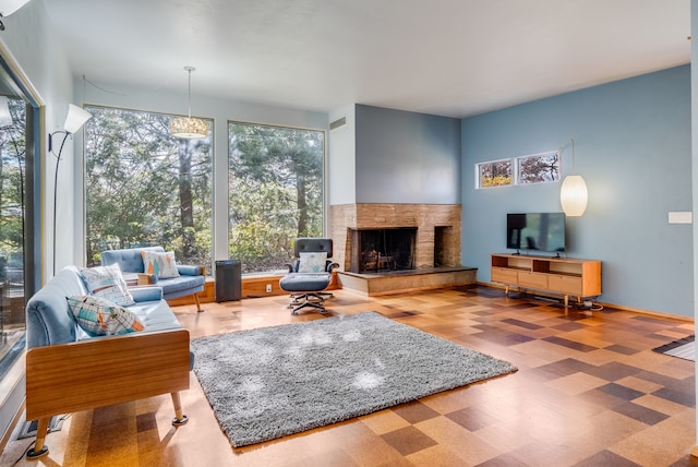 living room with a multi sided fireplace and wood-type flooring