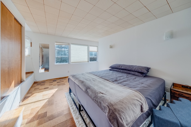 bedroom with light colored carpet and a closet