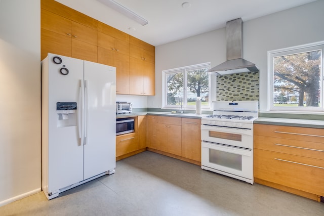 kitchen with white appliances, tasteful backsplash, wall chimney exhaust hood, and sink