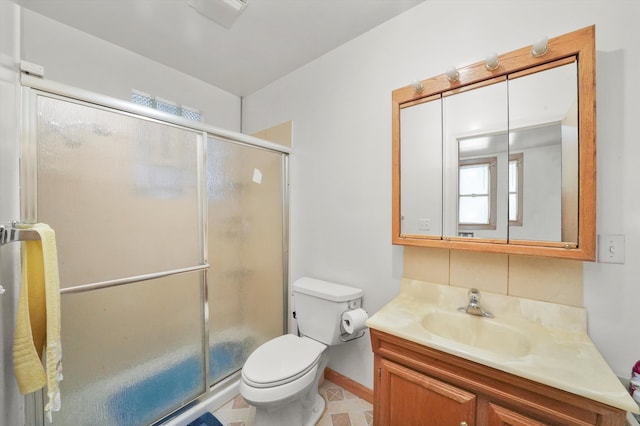 bathroom featuring vanity, toilet, and walk in shower