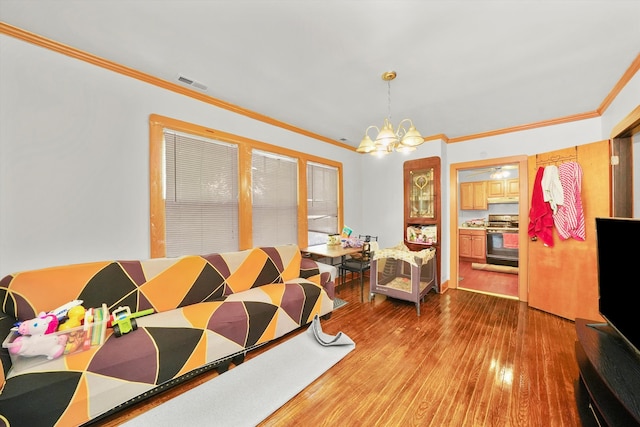 bedroom featuring ornamental molding, hardwood / wood-style flooring, and a chandelier