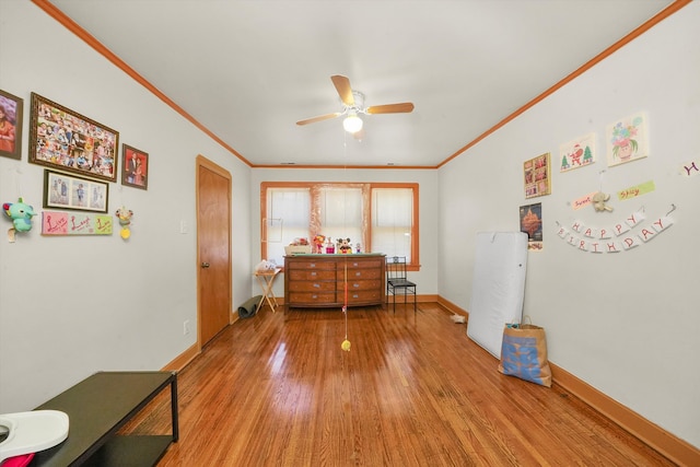 misc room featuring crown molding, hardwood / wood-style flooring, and ceiling fan