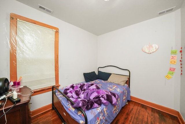 bedroom with dark hardwood / wood-style flooring