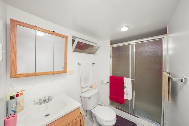 bathroom with vanity, toilet, walk in shower, and tile patterned flooring