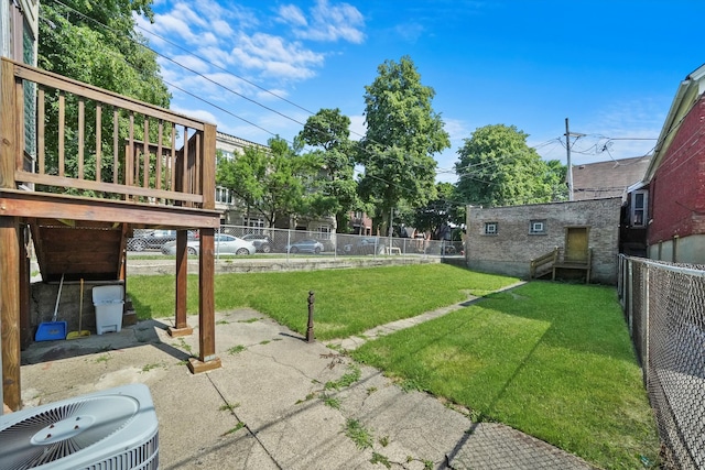 view of yard with a wooden deck, cooling unit, and a patio area