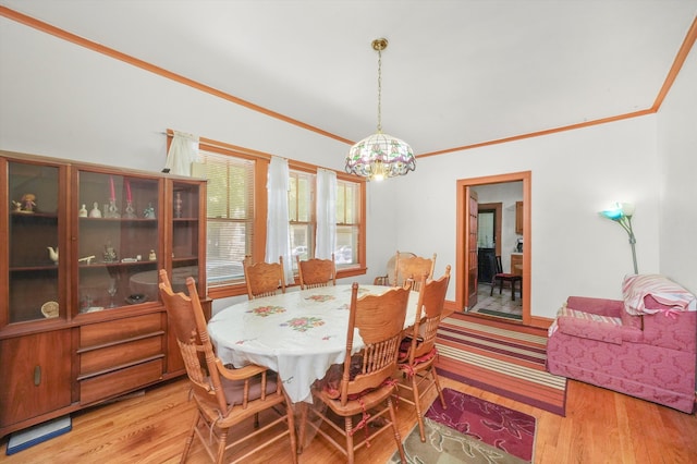 dining area featuring light hardwood / wood-style floors and ornamental molding