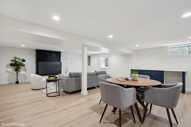 dining room with a wealth of natural light and light wood-type flooring