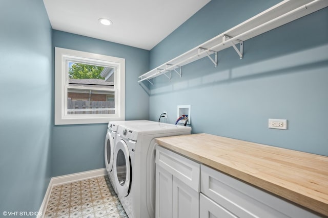 washroom featuring cabinets and separate washer and dryer