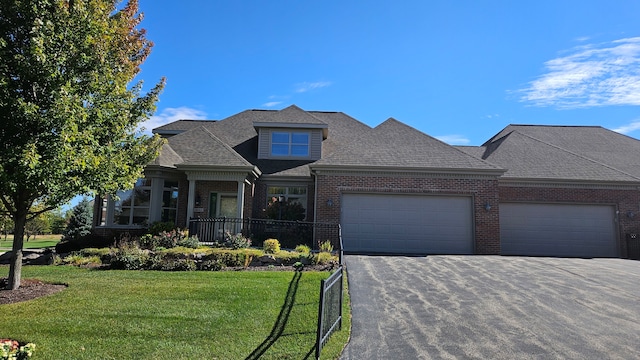 view of front of house featuring a garage and a front lawn