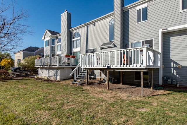 back of property featuring a yard and a wooden deck