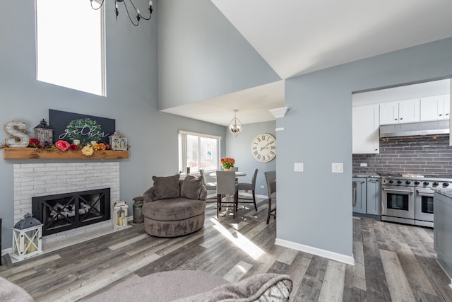 living room featuring hardwood / wood-style floors and a brick fireplace