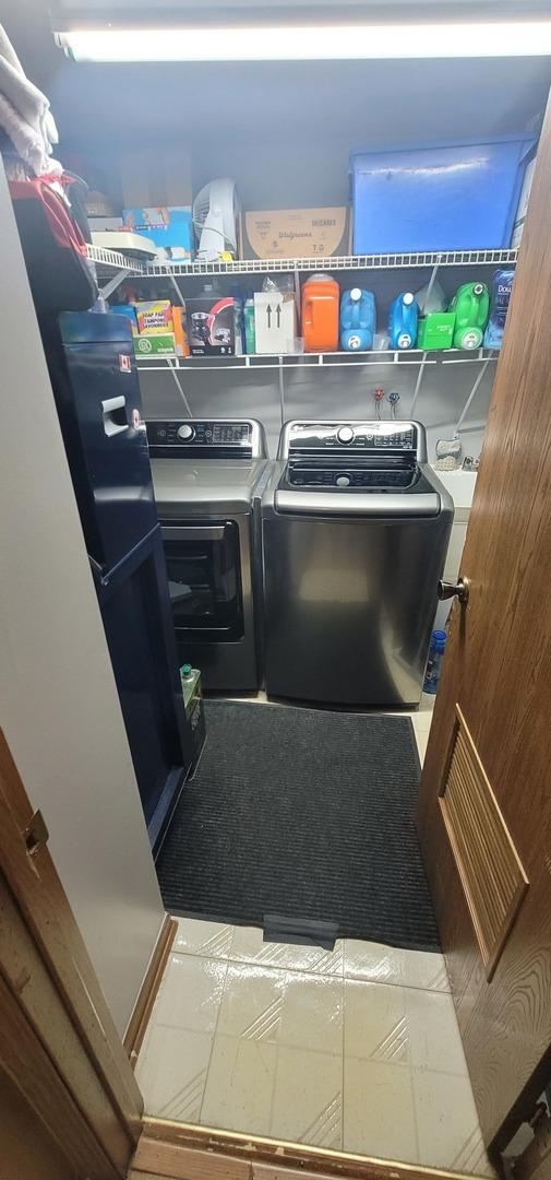 laundry room featuring washing machine and clothes dryer