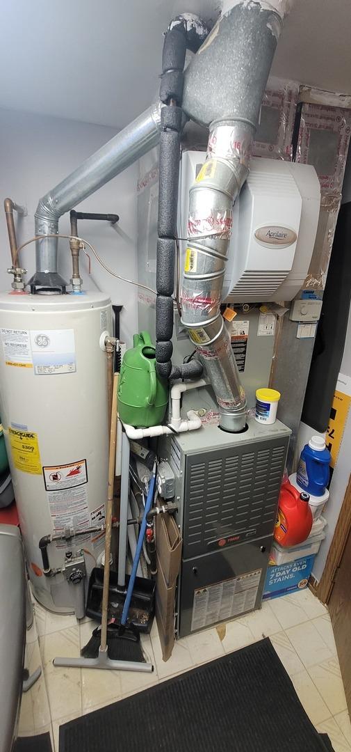 utility room with water heater