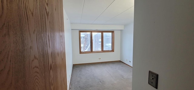 spare room featuring light colored carpet