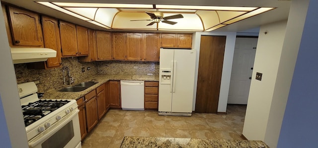 kitchen featuring decorative backsplash, white appliances, ceiling fan, sink, and stone countertops