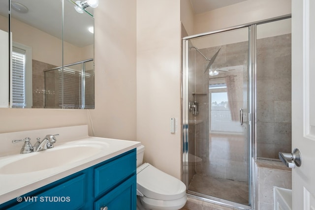 bathroom with vanity, toilet, and a shower with door