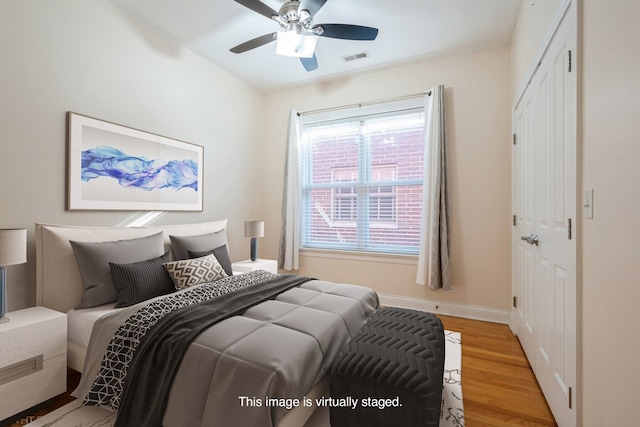 bedroom with light hardwood / wood-style floors and ceiling fan