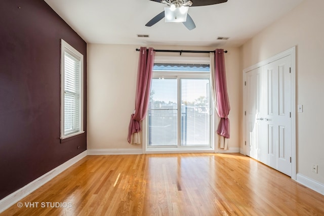 empty room featuring light wood-type flooring and ceiling fan