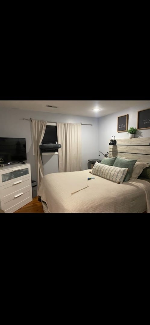 bedroom with hardwood / wood-style floors