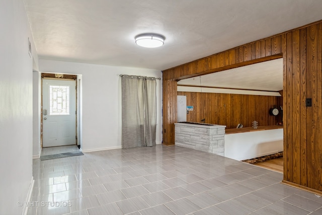 spare room featuring wooden walls