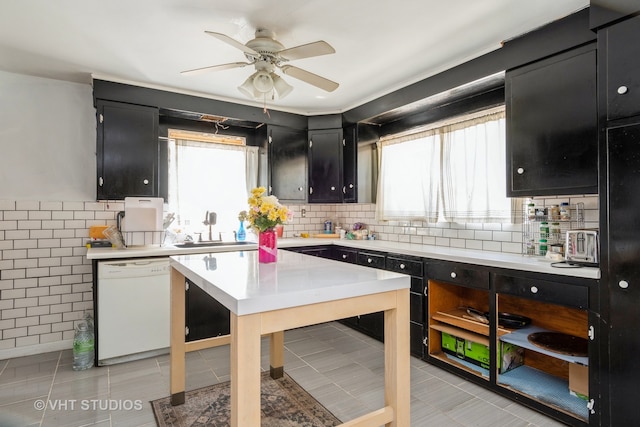 kitchen featuring a wealth of natural light, sink, dishwasher, and ceiling fan