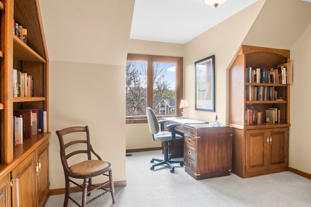 carpeted office featuring lofted ceiling