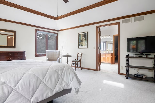 bedroom with ornamental molding, light colored carpet, connected bathroom, and ceiling fan