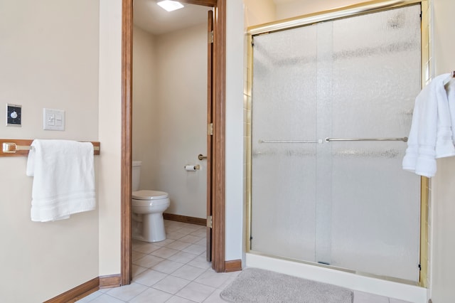 bathroom with tile patterned flooring, toilet, and walk in shower