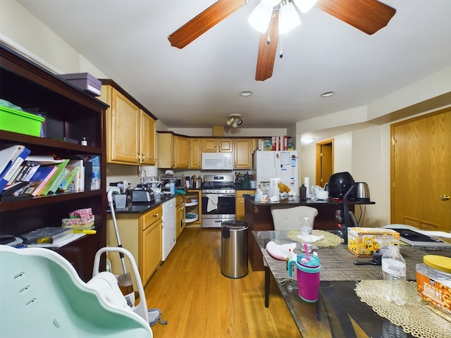 kitchen featuring white appliances, ceiling fan, and light wood-type flooring